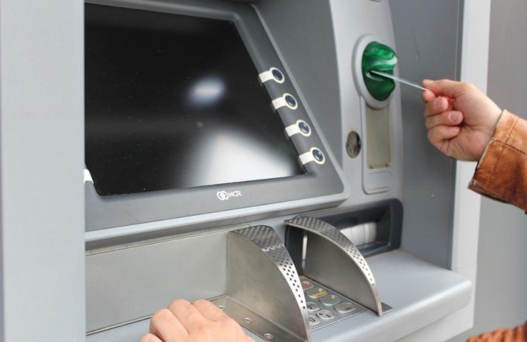 Un uomo cerca di utilizzare la propria carta ad uno sportello ATM