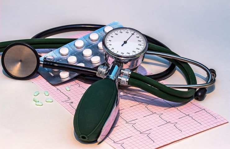 A medical stethoscope and heart pills