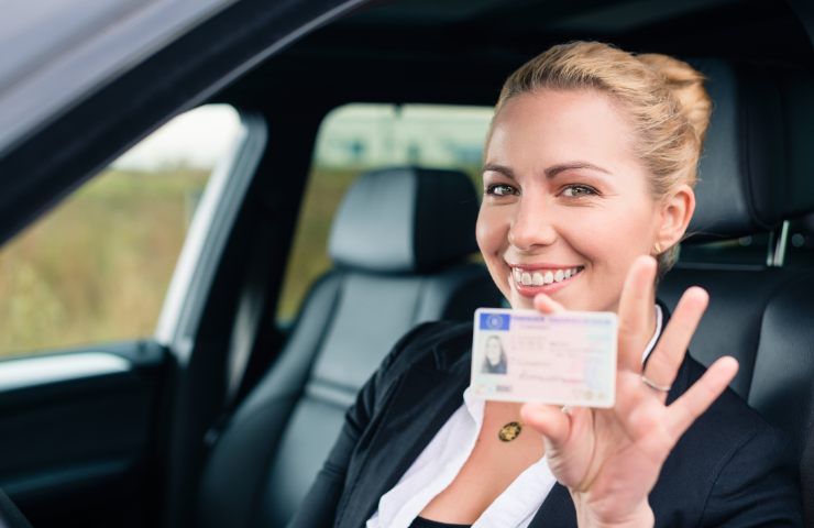 Una donna che esibisce la propria patente