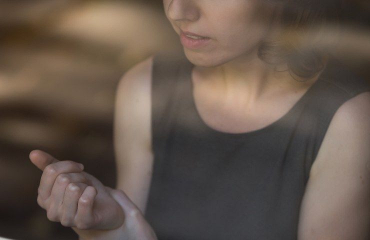 Una ragazza che soffre di dolori ad un polso