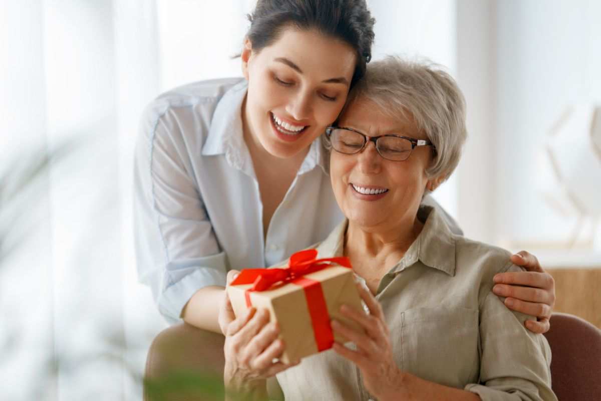 figlia dà regalo alla mamma felice