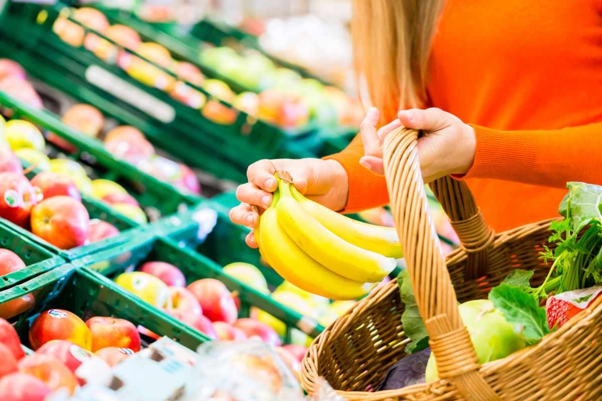 donna che mette nel cestino delle banane