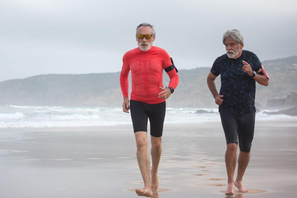 Due uomini si allenano in spiaggia