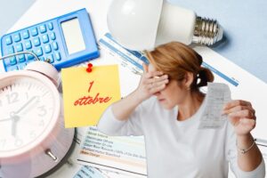 bollette, donna con la mano sugli occhi in segno di disperazione e post it con scritto 1 ottobre