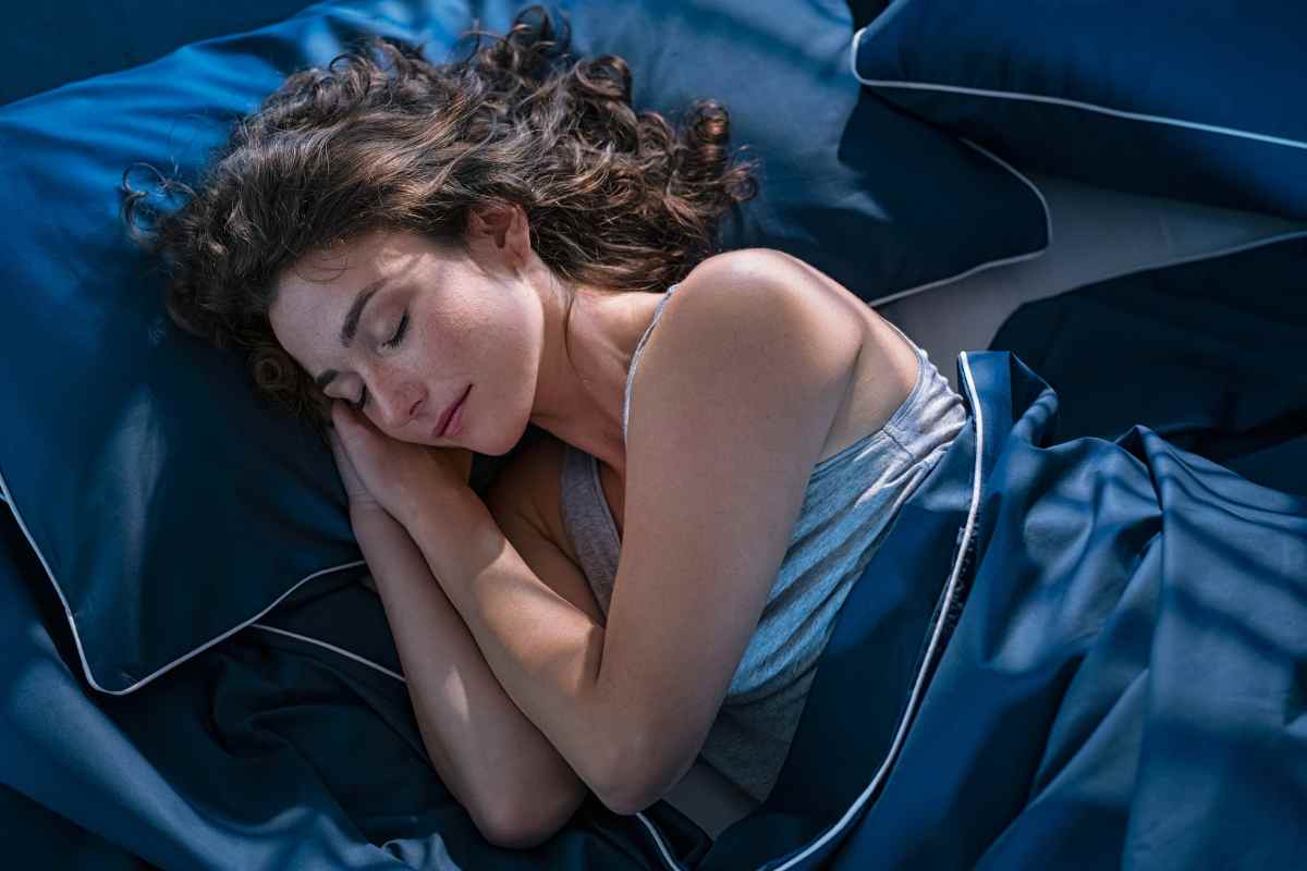 donna dorme sotto le coperte