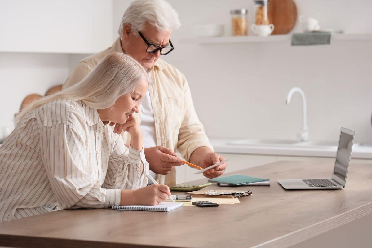pensionati in cucina che controllano conti